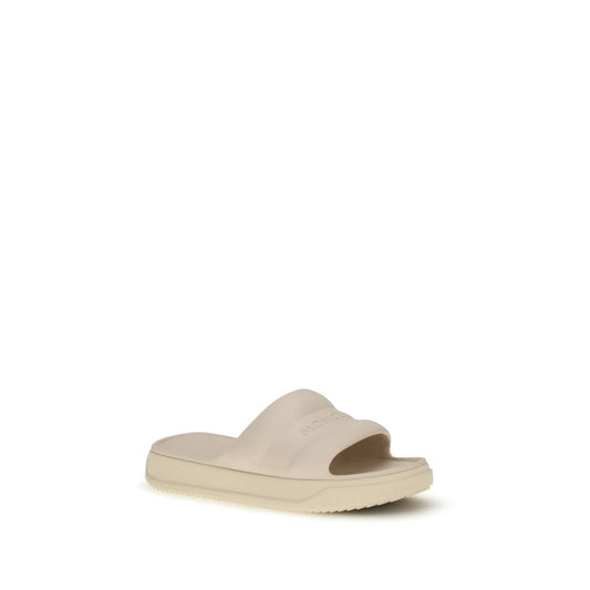 Moncler Beige Rubber Slippers Curated Luxury Accessories by Orvyn