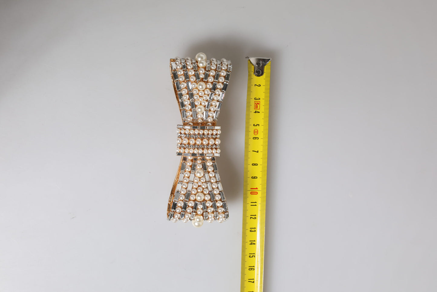 Dolce & Gabbana Gold Tone Brass Bow Crystal FauxPearl Embellished Brooch Curated Luxury Accessories by Orvyn
