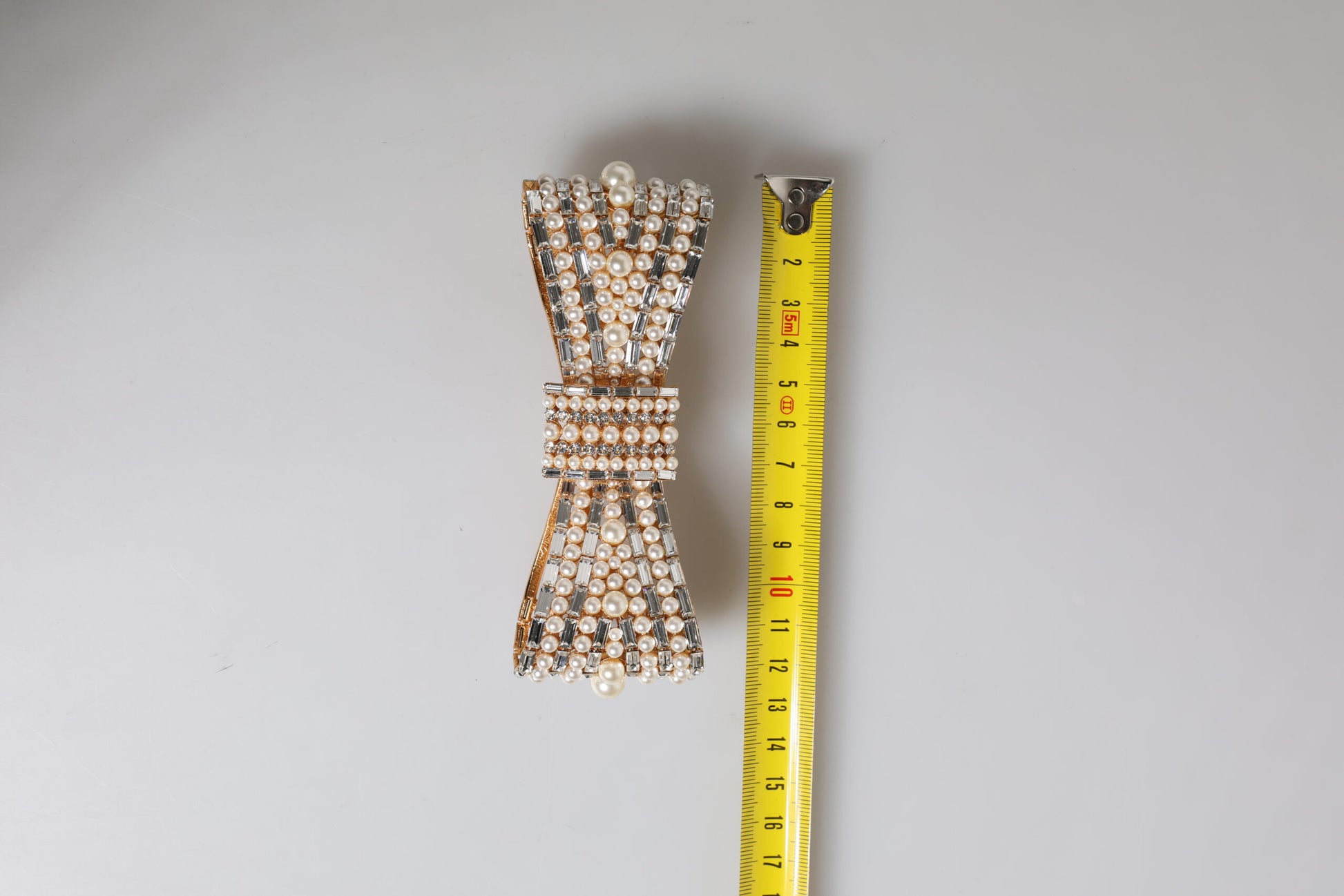 Dolce & Gabbana Gold Tone Brass Bow Crystal FauxPearl Embellished Brooch Curated Luxury Accessories by Orvyn