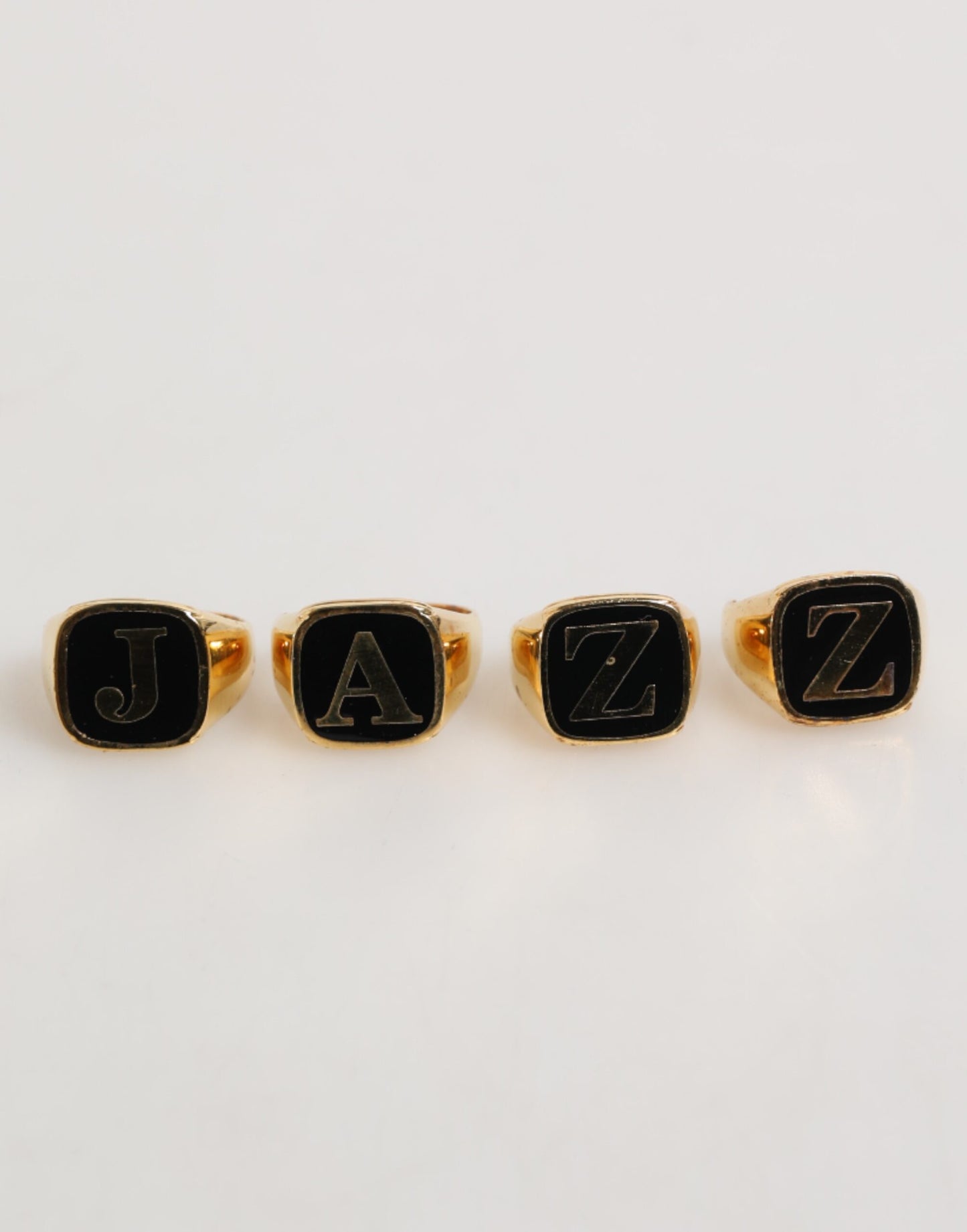 Dolce & Gabbana Gold Tone Brass JAZZ Letter Set 4 Pieces Adjustable Ring Curated Luxury Accessories by Orvyn