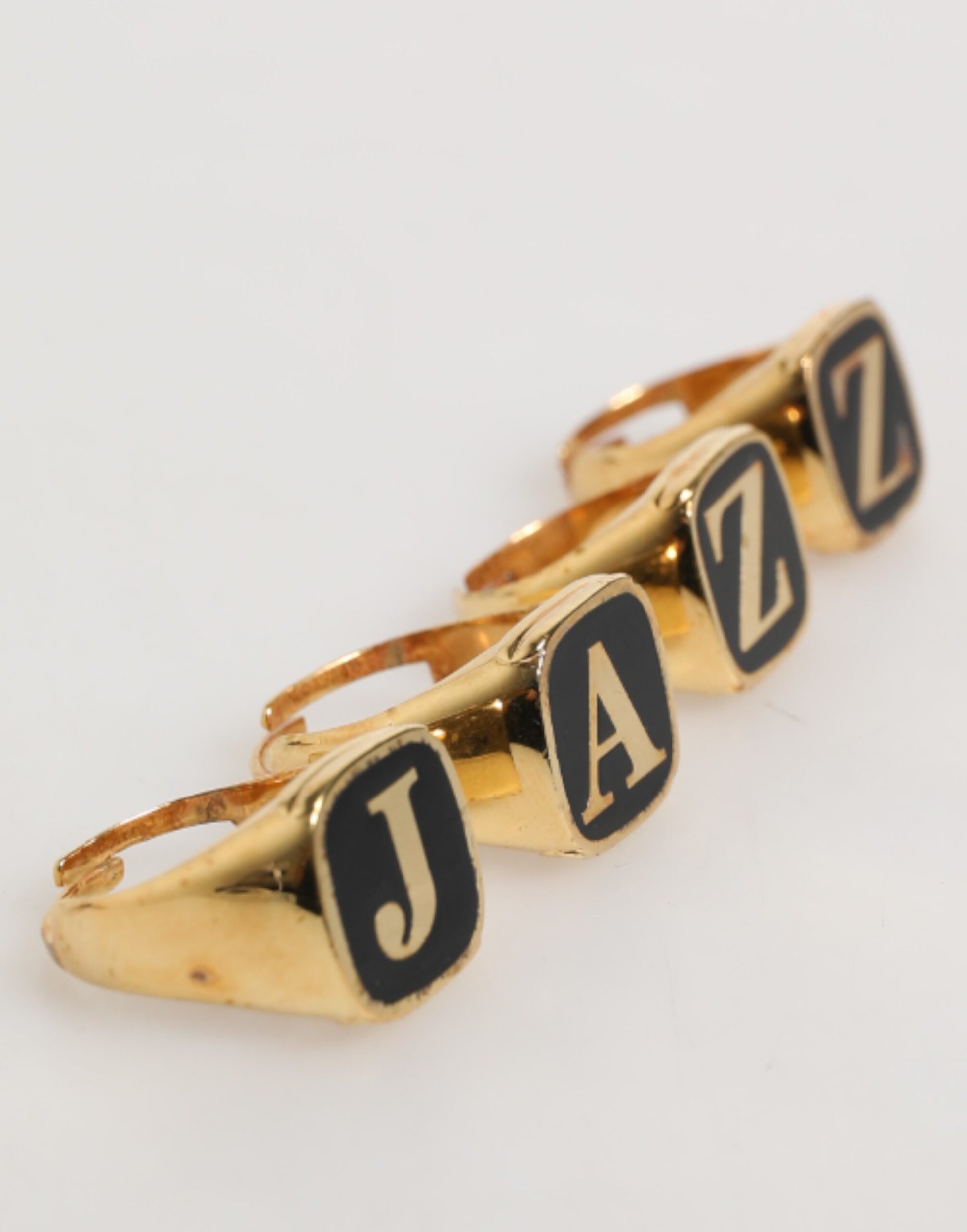 Dolce & Gabbana Gold Tone Brass JAZZ Letter Set 4 Pieces Adjustable Ring Curated Luxury Accessories by Orvyn